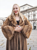 Vintage Canadian brown mink fur coat with long sleeves, worn by woman with long blonde hair posing in city street setting.