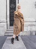 Luxurious beige fur coat, elegant woman posing on street