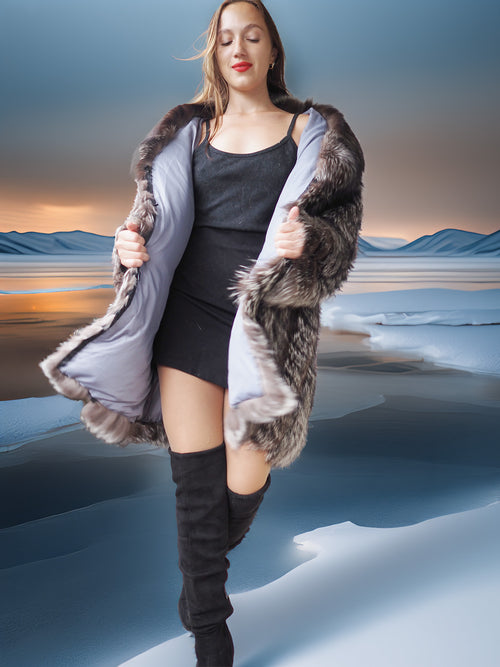 Woman in a fur-trimmed coat and knee-high boots standing in a snowy landscape.