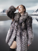 Woman wearing a fur coat with a mountainous landscape in the background