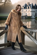 Tan mink fur hooded coat with ribbed panel detailing along the lower body