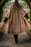 Back view of tan mink fur coat with hood and flared ribbed lower section