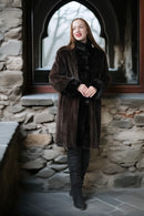 Dark sheared mink coat with button closure and plush fur cuffs, long length