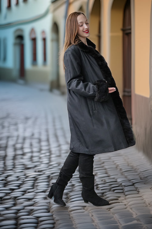 Dark fur coat with button placket and long sleeves, side view
