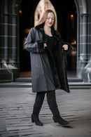 Dark mink coat with wide turn-back collar, button details, and short sleeves