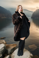 Dark mink coat over a fitted dress, showing stand collar and button closure