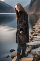Dark fur button-front coat with plush cuffs, knee-length, side view