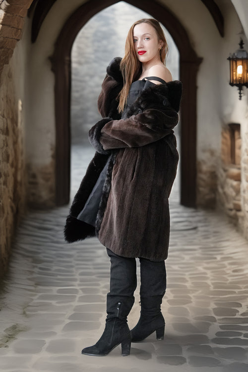 Long dark mink coat with fur hood/collar, button front, and plush fur-trimmed sleeves