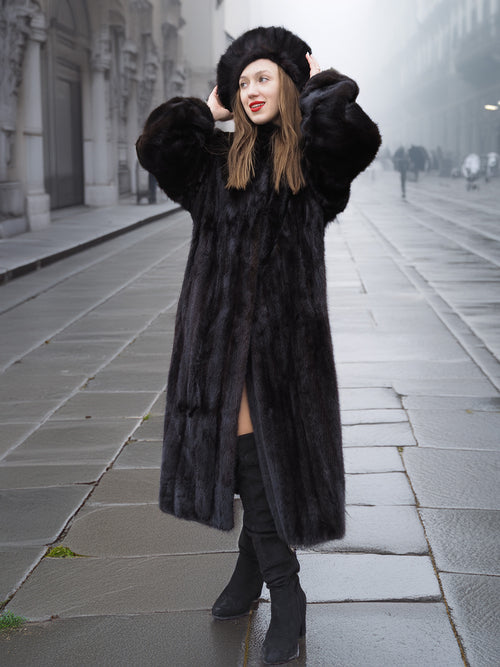 Dark ranch black mink fur coat with matching hat, styled for winter elegance. Ideal for luxury cold-weather outerwear collections.