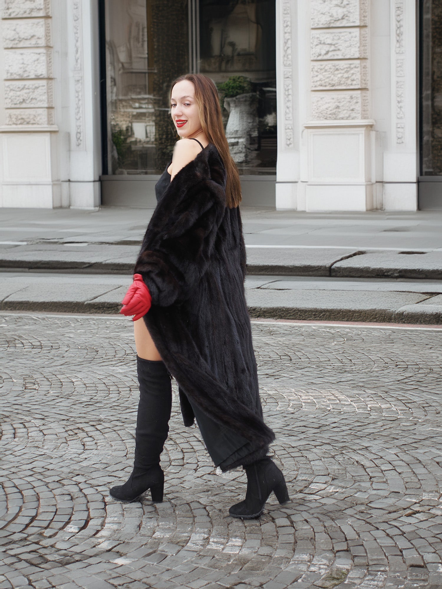Side view of woman in dark ranch black mink fur coat, walking confidently. Warm and stylish fur outerwear for winter.