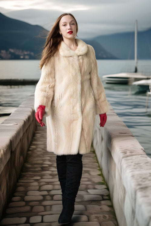 Ivory mink coat with textured front and full-length cut, red gloves