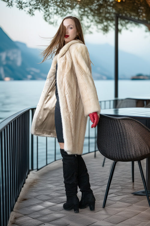 Ivory mink coat side view with plush collar and red gloves