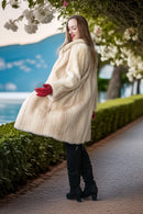 Ivory mink coat with plush collar, long sleeves, red gloves