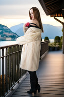 Ivory mink coat, side view with plush texture and draped open-front look.