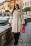 Ivory faux mink coat with long sleeves, button-front closure, and mid-calf length