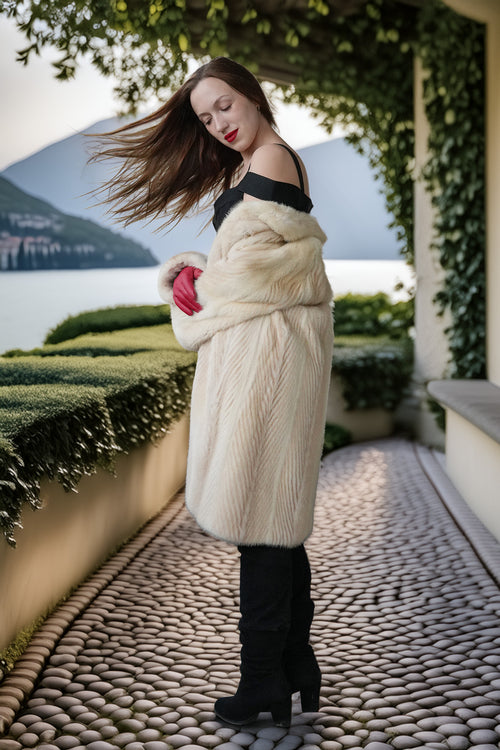 Ivory mink coat with raised collar and red gloves, long straight silhouette