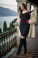 Ivory mink coat with plush fur cuffs and an open, collarless draped front.