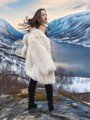 Soft Plush Blush Fox Jacket S/M in motion, emphasizing plush fur and stylish silhouette in a scenic winter landscape.