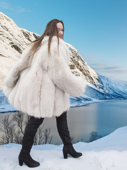 Soft Plush Blush Fox Jacket S/M styled in motion, showcasing full fur volume and elegant winter outerwear in a snowy mountain view.