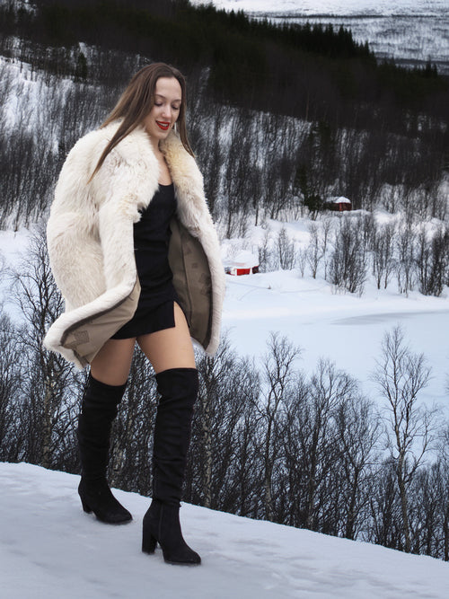 Model walking in snow with Soft Plush Blush Fox Jacket S/M draped over shoulders, revealing satin lining and winter-ready style.