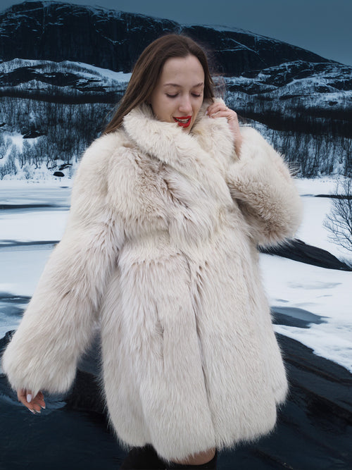 Close-up of Soft Plush Blush Fox Jacket S/M showing thick white fox fur and elegant tailoring in a snowy outdoor environment.