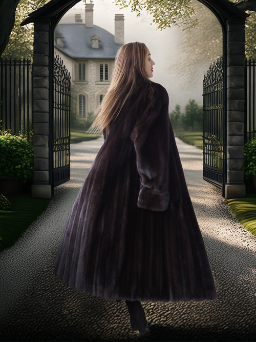 Woman in a long coat walking towards a grand house through an archway.