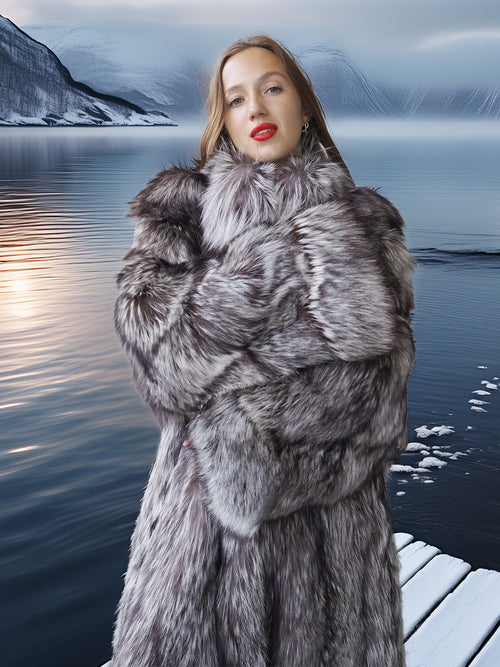 Woman wearing a fur coat with a mountainous landscape in the background