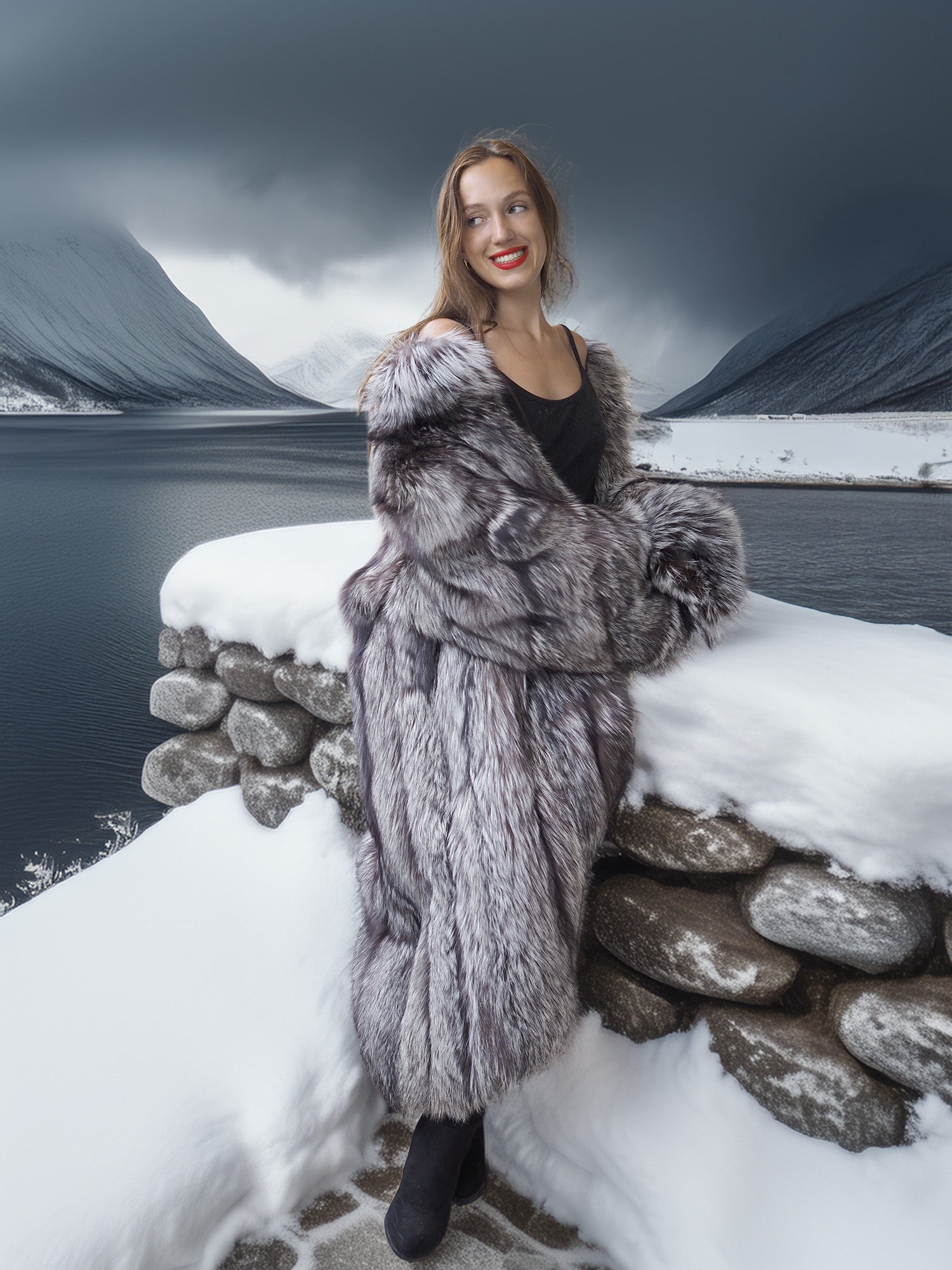 Woman in a fur coat standing on a snowy ledge with mountains in the background