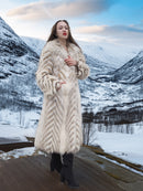 Two Tone Fox Coat Size XS/S worn in a scenic snowy valley, highlighting the coat’s chevron pattern and full-length fur design.