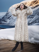 Model in Two Tone Fox Coat Size XS/S posing on a snowy deck, emphasizing the coat’s voluminous chevron fur and elegant winter style.