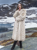 Full-length Two Tone Fox Coat with chevron fur pattern and shawl collar, styled in a snowy mountain scene for high-end winter fashion.