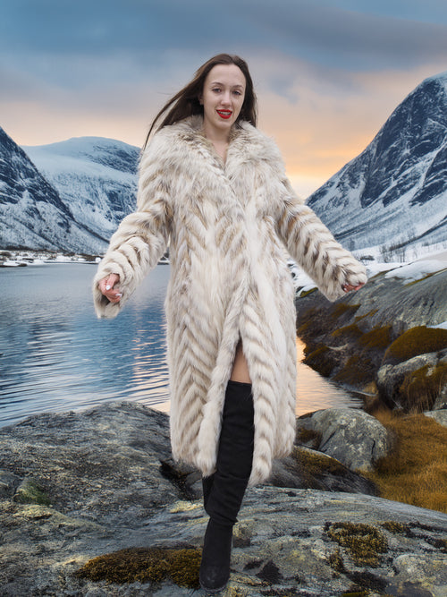 Two Tone Fox Coat with shawl collar and chevron design in size XS/S, styled in a snowy mountain setting for luxury winter fashion appeal.
