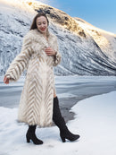 Two Tone Fox Coat Size XS/S styled in a snowy landscape, highlighting the coat’s chevron fur pattern and elegant silhouette.