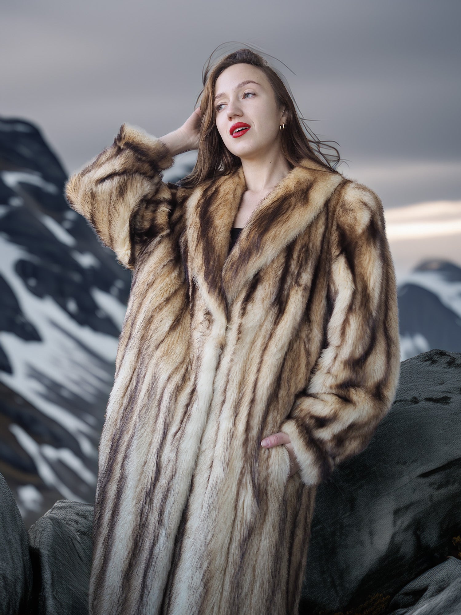 Woman wearing a fur coat standing against a mountainous background