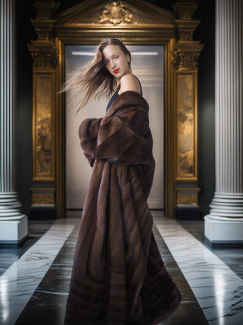 Woman in a brown fur coat standing in an elegant interior setting with classical architecture.