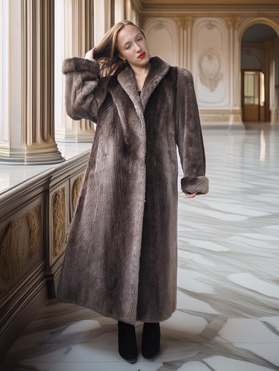 Woman wearing a long fur coat in an elegant interior setting
