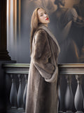 Woman in a long fur coat standing in an elegant interior setting