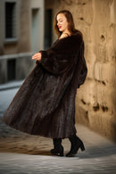 Woman wearing a long brown fur coat in an urban setting