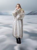 Person wearing a long fur coat in a snowy landscape