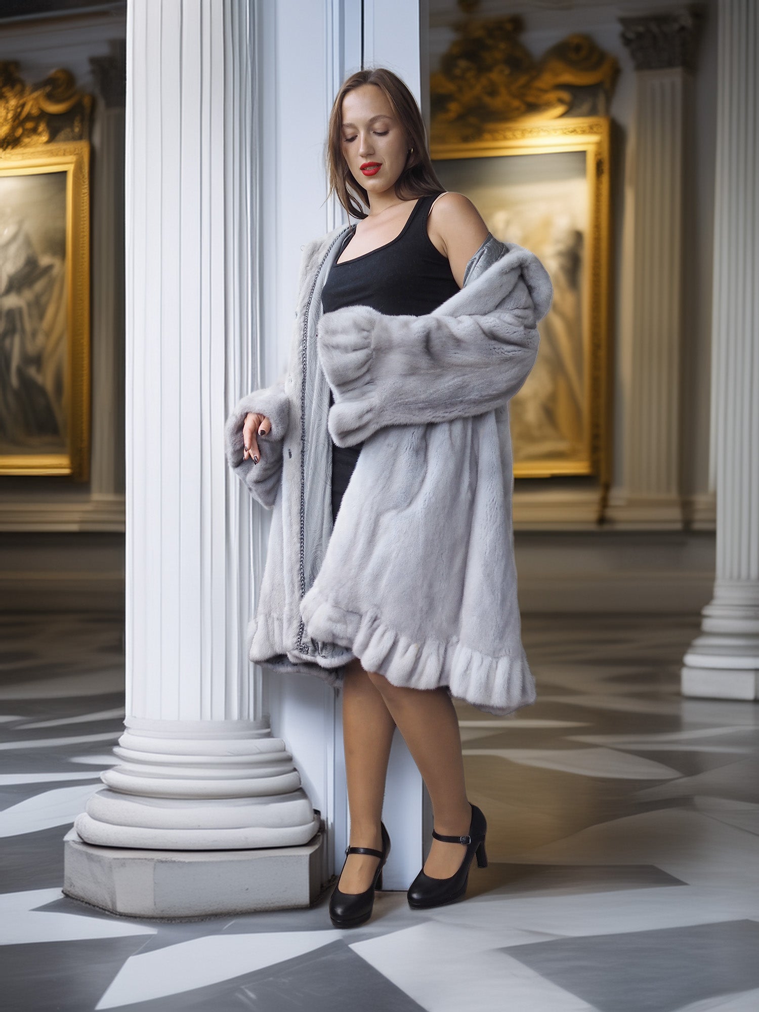 Woman in a gray coat standing in an elegant interior setting with classical architecture.