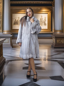 Woman wearing a fur coat in an elegant interior setting
