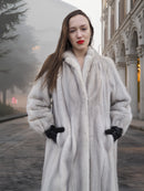 Close-up of Sapphire Grey Mink Fur Coat S Petit Excellent with hands in pockets, highlighting plush texture and tailored fit.