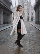 Model smiles in Sapphire Grey Mink Fur Coat S Petit Excellent with iconic cathedral in background, blending fashion and heritage.