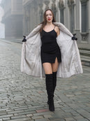 Model opens Sapphire Grey Mink Fur Coat S Petit Excellent to reveal black mini dress, combining luxury outerwear with modern fashion.