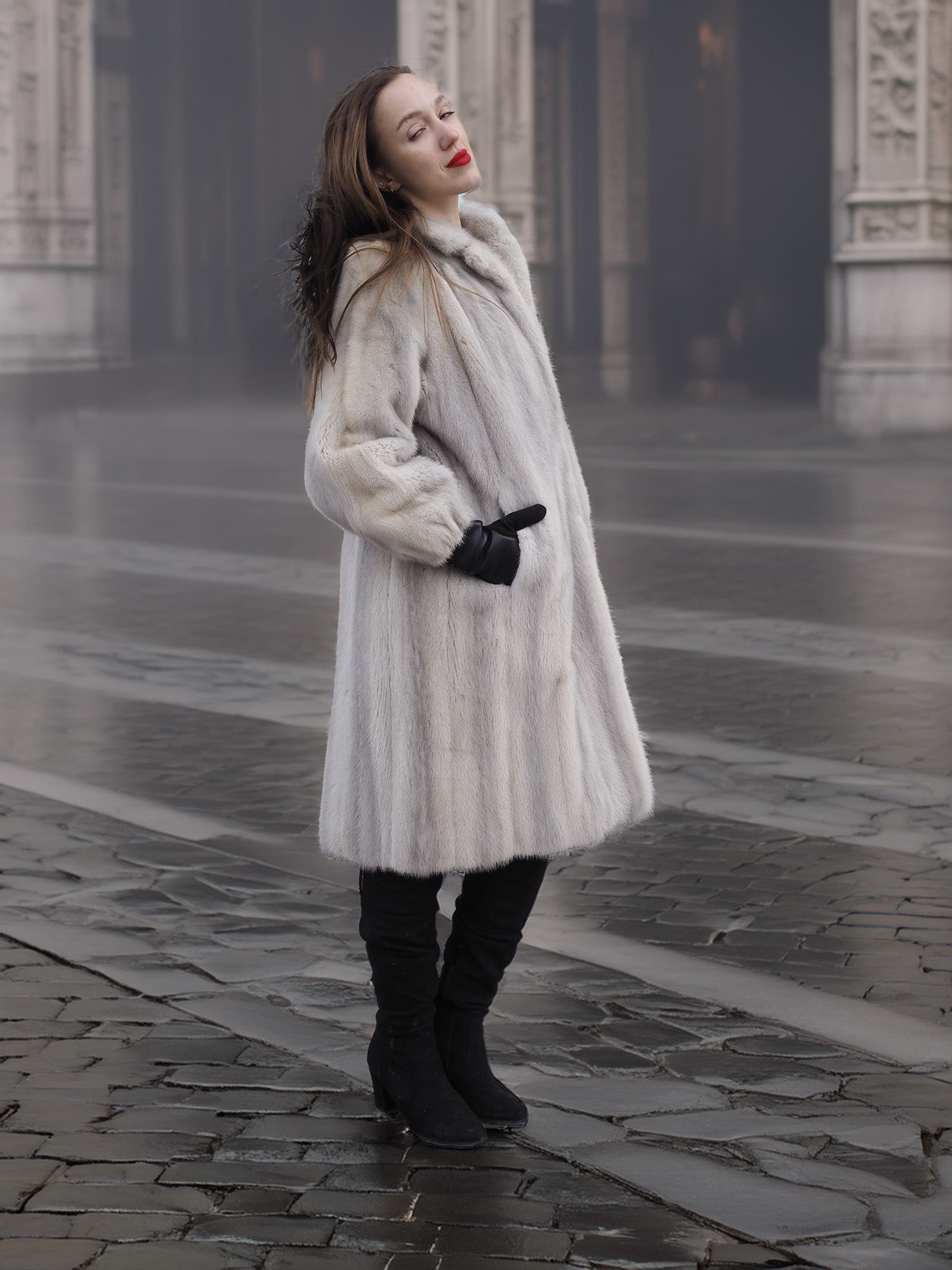 Model poses in Sapphire Grey Mink Fur Coat S Petit Excellent on a foggy street, showcasing the coat’s plush texture and warmth.