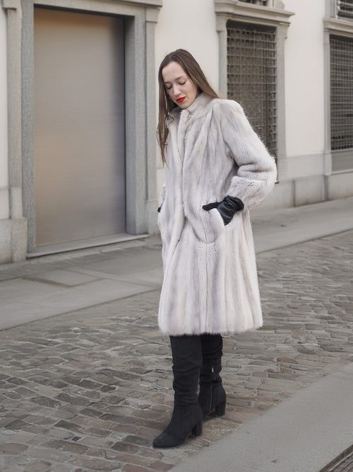 Model walks in Sapphire Grey Mink Fur Coat S Petit Excellent on cobblestone streets, showcasing vintage-inspired fur fashion.