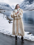 Coyote fur coat with white fox trim by snowy stream