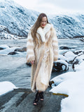 Coyote fur coat with white fox trim in winter mountains