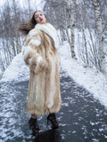 Coyote fur coat with white fox trim on snowy cliff