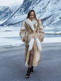 Stylish coyote fur coat with white fox trim by icy lake